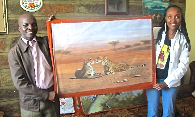 Wycliffe Ndwgia with one of his paintings and Website Owner, Gathinja