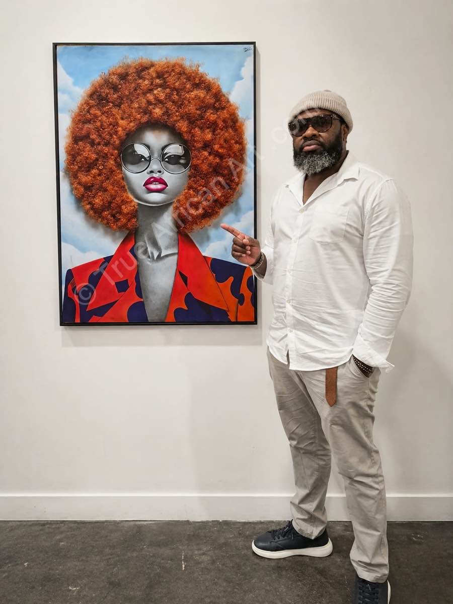 The artist pointing to his painting on True African Art .com